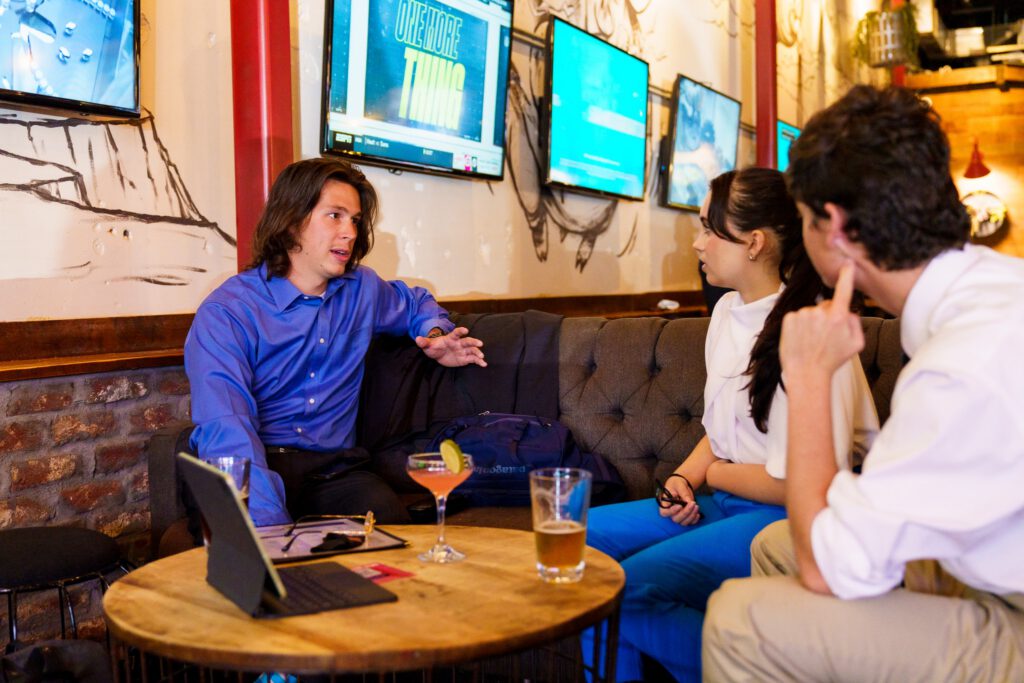 A group of young professionals network at happy hour.