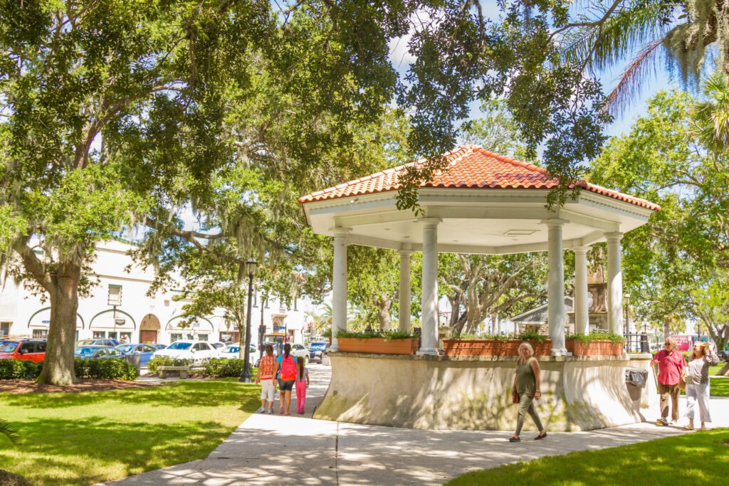 A gazebo / pergola with spanish architecture in a park in historical town square at St. Augustine, Florida, USA over a blue deep sky in a summer day.