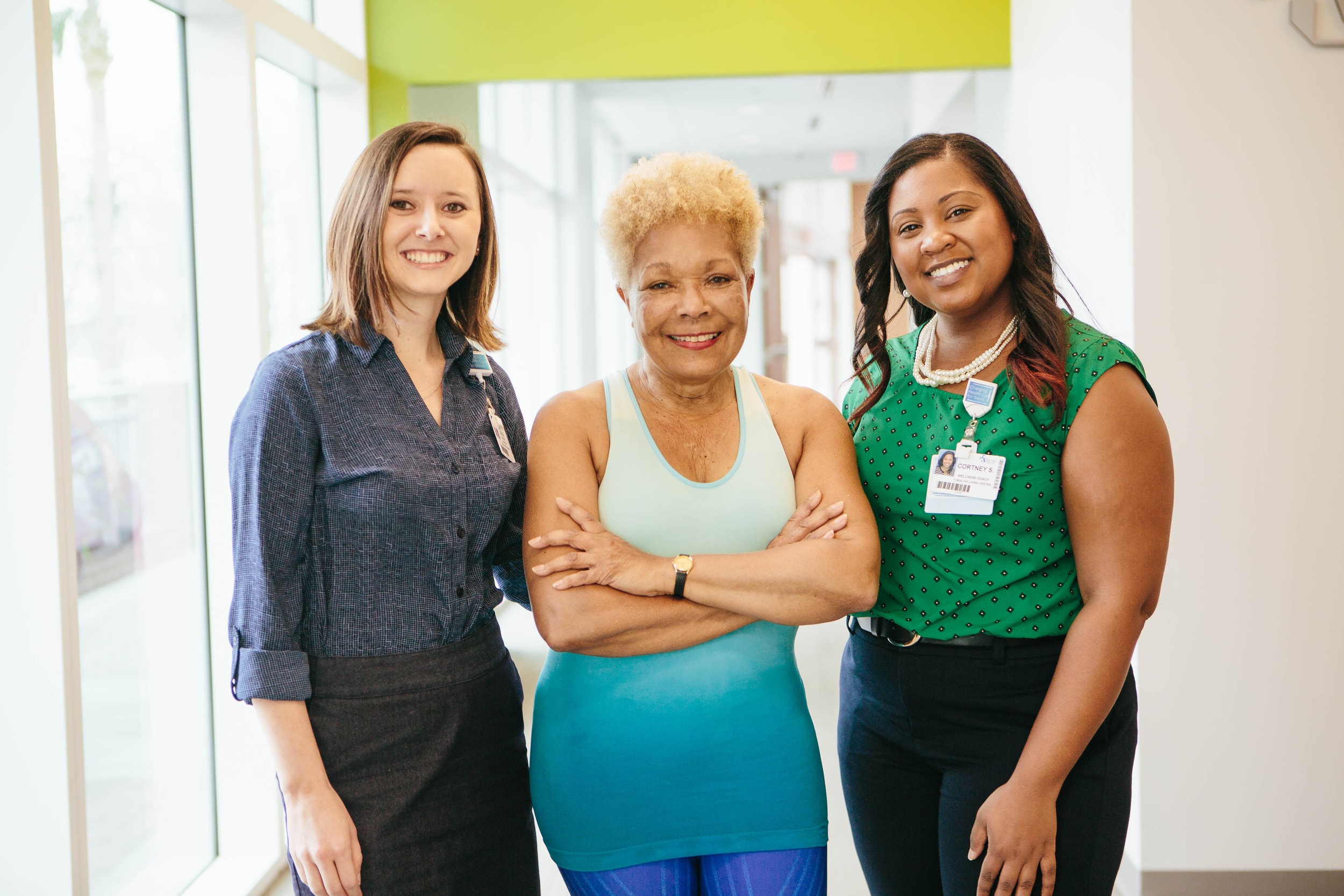 Three professional woman pose for a photo.