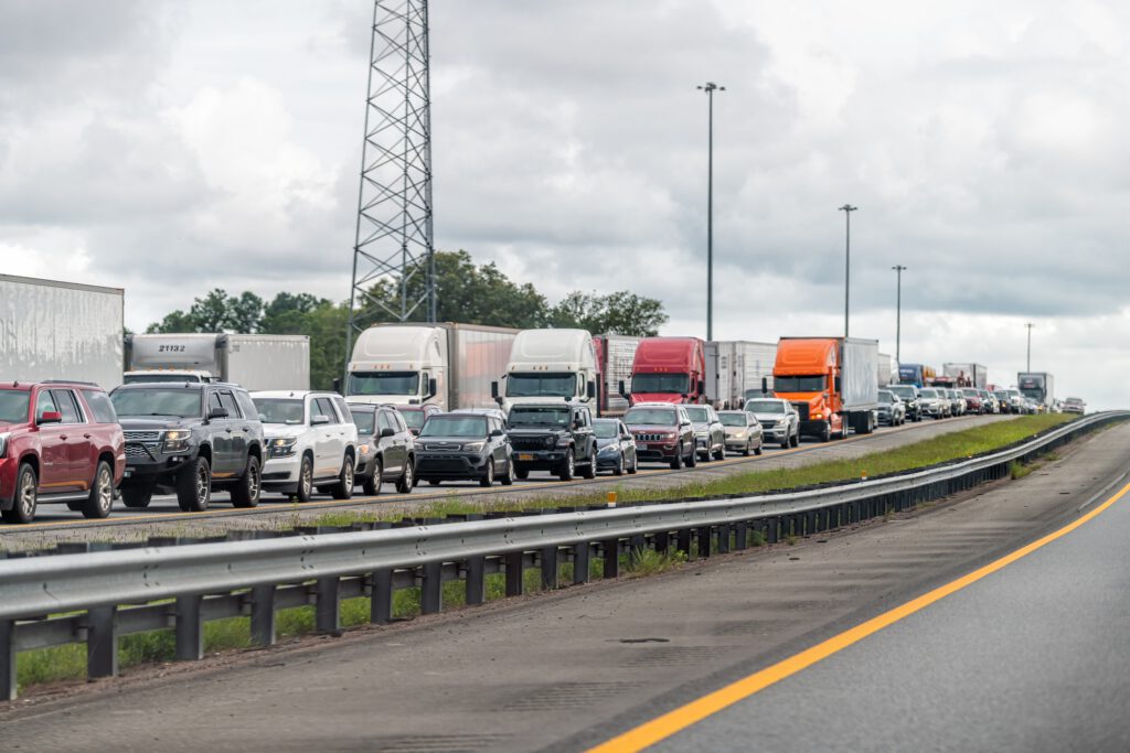 Interstate highway i95 driving car pov near Jacksonville, Florida and long line traffic jam of many trucks and vehicles