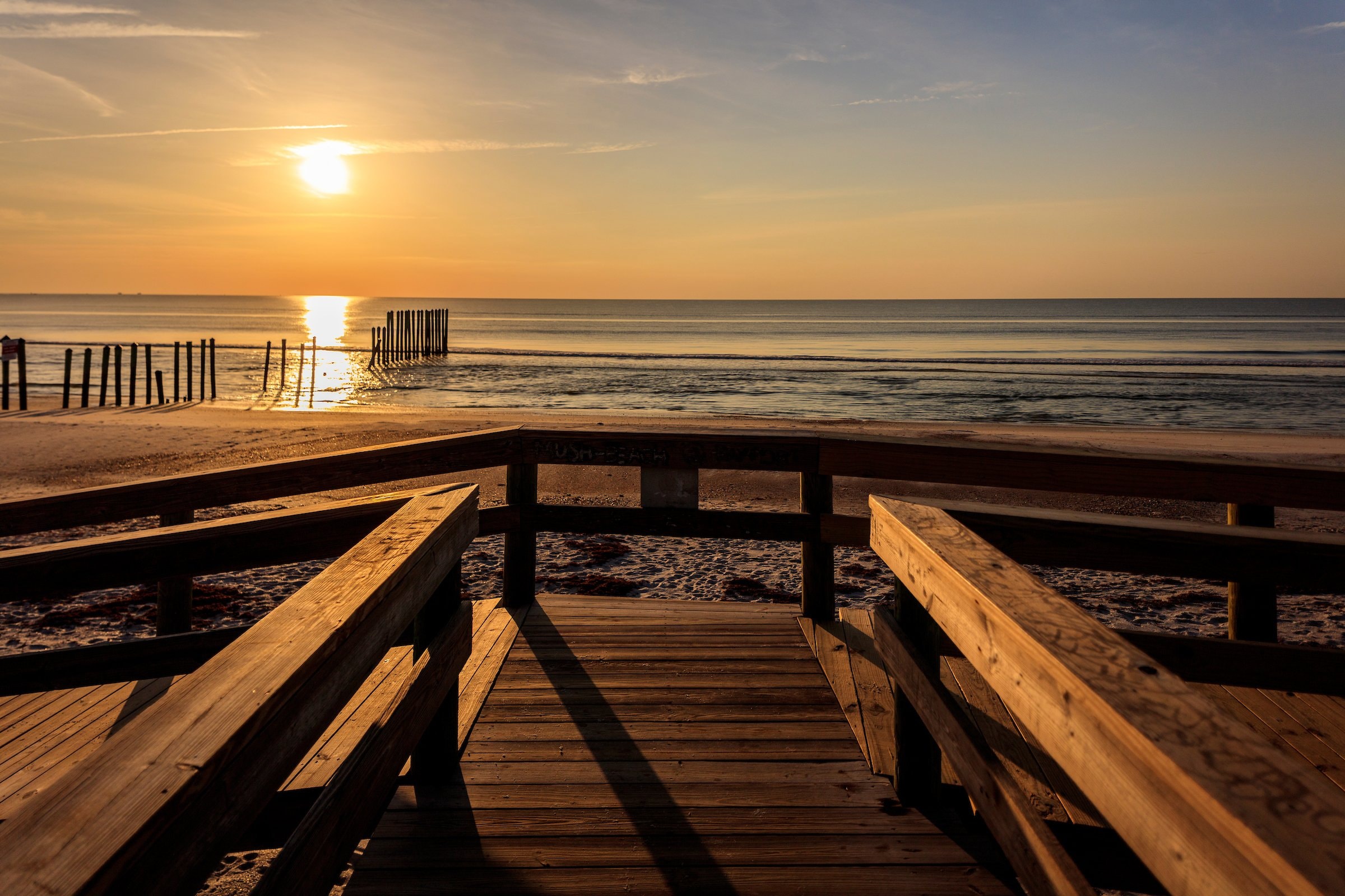 A boardwalk view at sunset.
